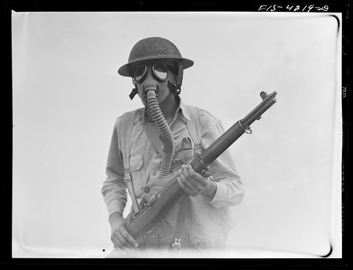 Fort Riley, Kansas. Soldier of a cavalry rifle unit going through a smokescreen during a field problem