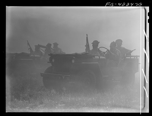 Fort Riley, Kansas. Jeeps of a mechanized cavalry reconnaissance unit in a smokescreen during a field problem
