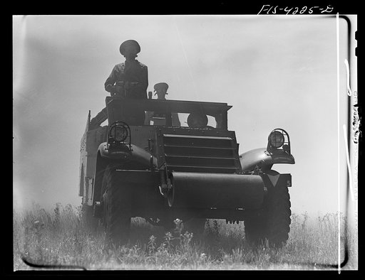 Fort Riley, Kansas. A scout car of a mechanized cavalry reconnaissance unit in a smokescreen during a field problem