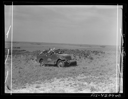 Untitled photo, possibly related to: Fort Riley, Kansas. A scout car of a mechanized cavalry reconnaissance unit in a smokescreen during a field problem