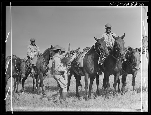 Fort Riley, Kansas. Cavalry machine gun unit dismounting to get guns into action