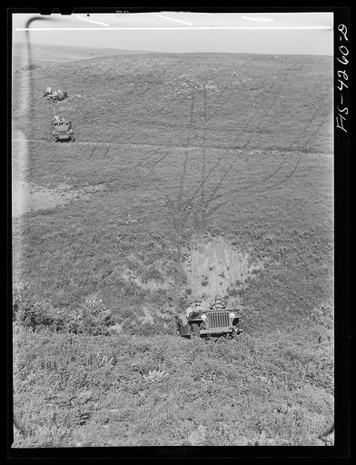 Untitled photo, possibly related to: Fort Riley, Kansas. Jeeps going down a steep grade during a training demonstration