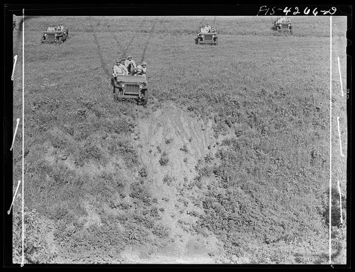 Untitled photo, possibly related to: Fort Riley, Kansas. Jeeps going down a steep grade during a training demonstration