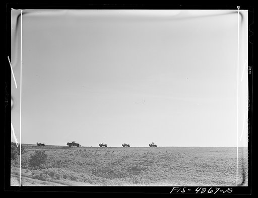 Fort Riley, Kansas. Vehicles of a reconnaissance unit about to return to camp after a day in the field on a problem