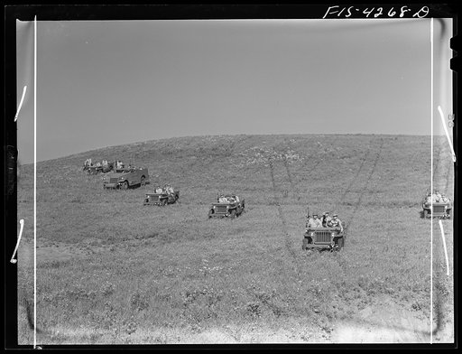Untitled photo, possibly related to: Fort Riley, Kansas. Jeeps going down a steep grade during a training demonstration