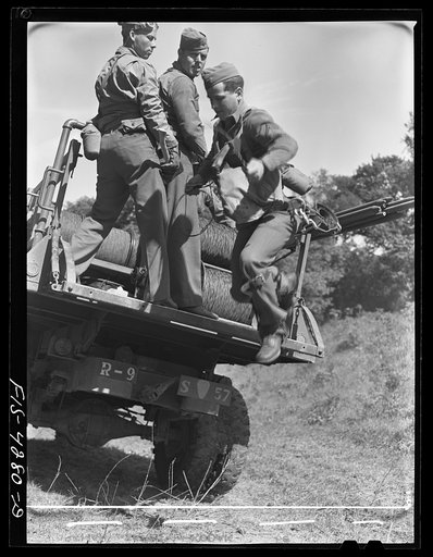 Fort Riley, Kansas. Laying wire from a truck of the Signal Corps during a field problem