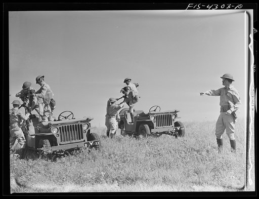Fort Riley, Kansas. Machine gun units of a reconnaissance outfit hurrying to set up their guns during a sham battle