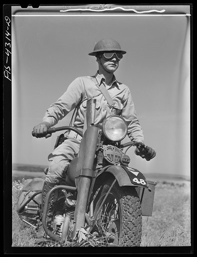 Fort Riley, Kansas. Motorcyclist serving as a messenger for his platoon of the mechanized cavalry reconnaissance unit