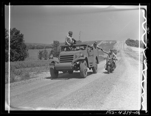 Fort Riley, Kansas. Delivering a message to a moving scout car during a field problem