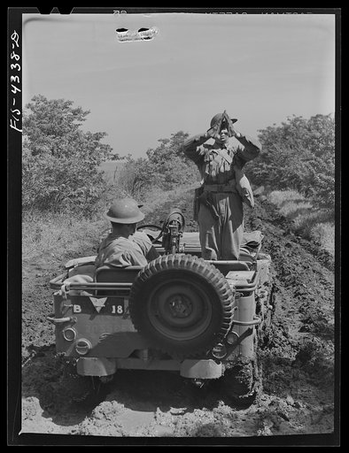 Fort Riley, Kansas. Signaling "cut engines" during a field problem of a reconnaissance unit