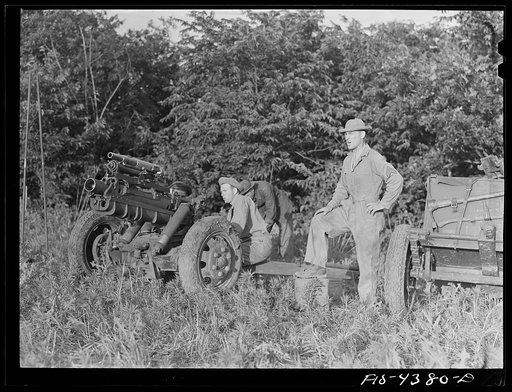 Fort Riley, Kansas. Lining up guns during artillery practice. The small thirty seven mm gun mounted on the howitzer is used only in training