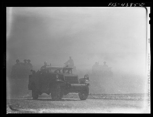 Fort Riley, Kansas. Scout car in a smokescreen during a sham battle