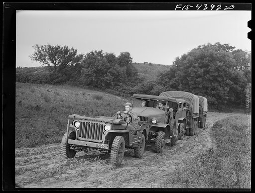 Fort Riley, Kansas. Trucks of the field artillery coming into bivouac at dawn