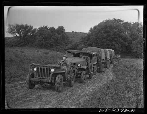 Fort Riley, Kansas. Trucks of the field artillery coming into bivouac
