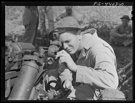 Fort Riley, Kansas. Sighting a 75 mm howitzer during artillery practice