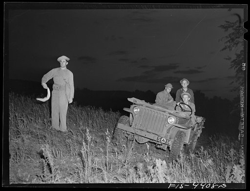 Fort Riley, Kansas. Leading a jeep into bivouac area during a blackout