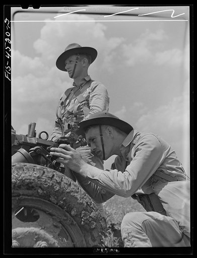Fort Riley, Kansas. Sighting a howitzer 75 mm gun during artillery practice