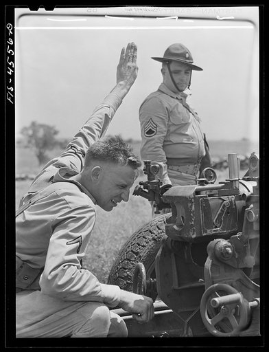 Fort Riley, Kansas. Sighting a howitzer 75 mm gun during artillery practice