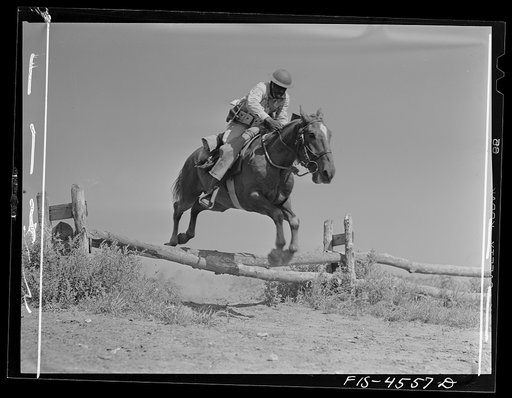 Fort Riley, Kansas. Soldier of a machine gun platoon going over an obstacle during a sham battle