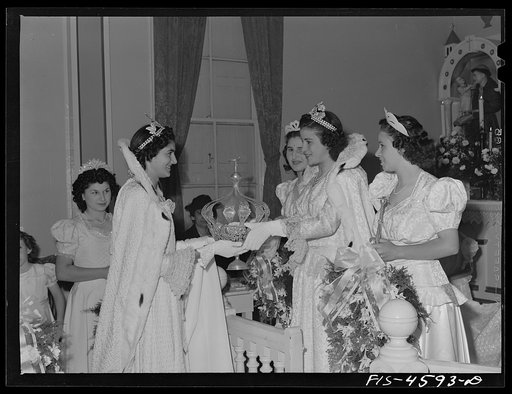 Last year's Queen of the fiesta of the Holy Ghost presents the crown to the new Queen of the fiesta. The new Queen will carry the crown in a parade to the church where she will be crowned. Santa Clara, California