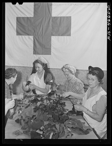 Washington, D.C. The District Red Cross is collecting, as part of the war conservation program, scraps of wool from tailors, manufacturers, and individuals. Here a group of volunteer women are sorting them and cutting off the threads to prepare the wool for reprocessing. There is a nationwide drive 