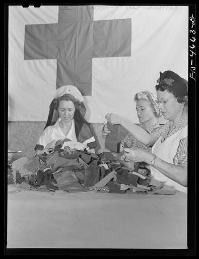 Untitled photo, possibly related to: Washington, D.C. The District Red Cross is collecting, as part of the war conservation program, scraps of wool from tailors, manufacturers, and individuals. Here a group of volunteer women are sorting them and cutting off the threads to prepare the wool for repro