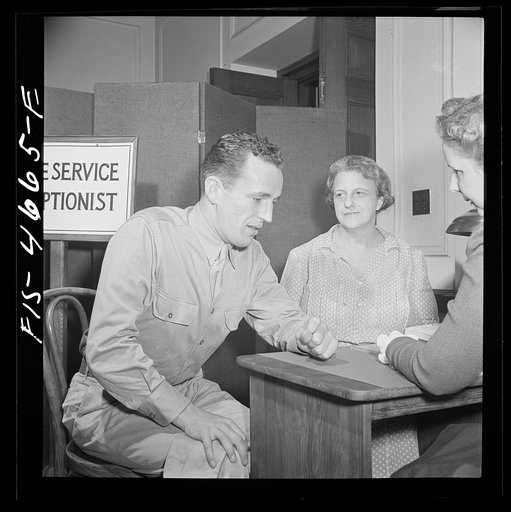 Untitled photo, possibly related to: Washington, D.C. A soldier asking for help for his mother at the Red Cross home service office. This service deals with personal problems of servicemen, acts as a liaison between them and their families at home and often helps them out with loans or grants of mon