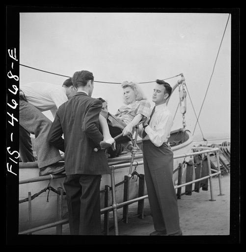 Untitled photo, possibly related to: Washington, D.C. Bandaging an "injured" arm as part of a course in first aid, aboard a Potomac River boat