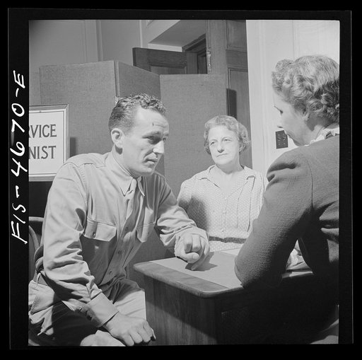 Washington, D.C. A soldier asking for help for his mother at the Red Cross home service office. This service deals with personal problems of servicemen, acts as a liaison between them and their families at home and often helps them out with loans or grants of money