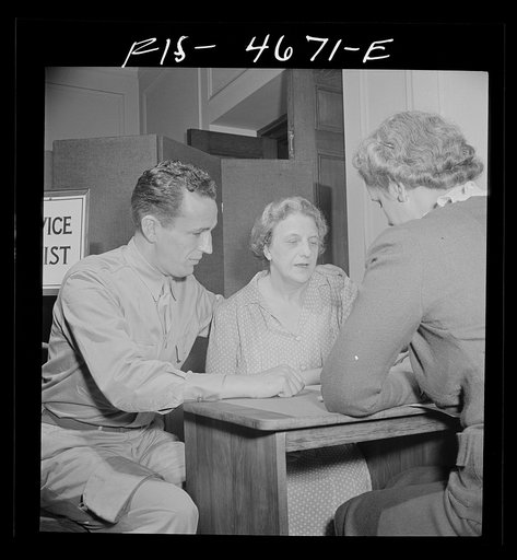 Untitled photo, possibly related to: Washington, D.C. A soldier asking for help for his mother at the Red Cross home service office. This service deals with personal problems of servicemen, acts as a liaison between them and their families at home and often helps them out with loans or grants of mon