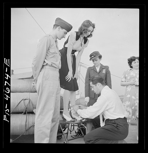 Untitled photo, possibly related to: Washington, D.C. Bandaging an "injured" arm as part of a course in first aid, aboard a Potomac River boat