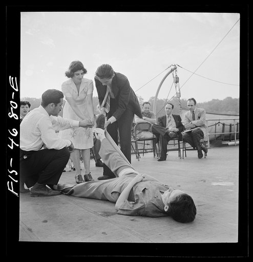 Untitled photo, possibly related to: Washington, D.C. Applying a splint to a "broken" leg as part of a course in first aid, aboard a Potomac River boat