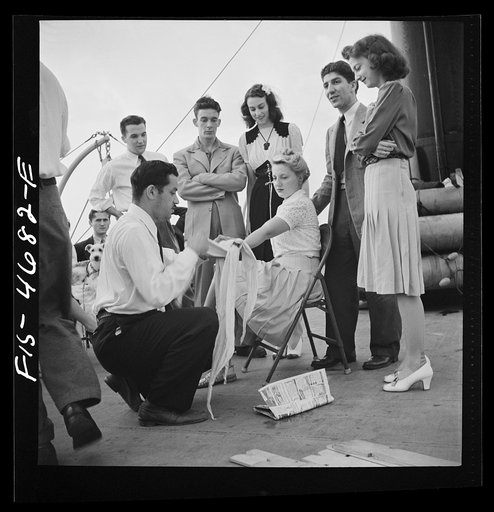 Untitled photo, possibly related to: Washington, D.C. Bandaging an "injured" arm as part of a course in first aid, aboard a Potomac River boat