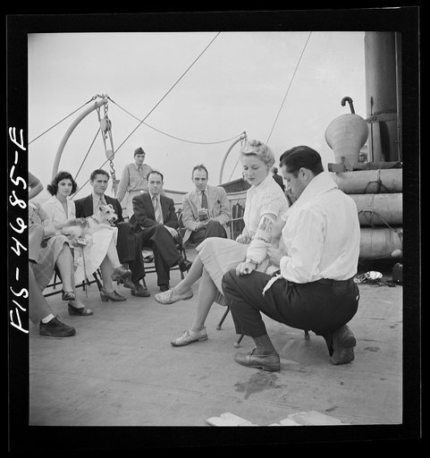 Untitled photo, possibly related to: Washington, D.C. Bandaging an "injured" arm as part of a course in first aid, aboard a Potomac River boat