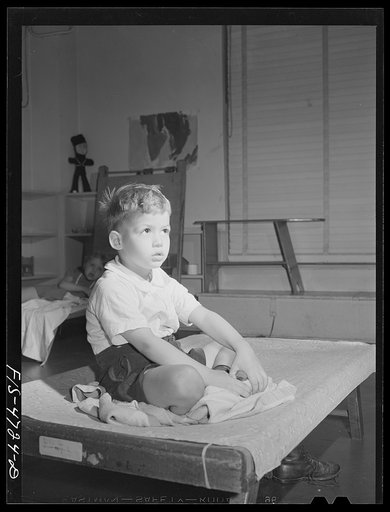 Queens, New York. Nursery school at the Queensbridge housing project. Child listening to a story after a nap