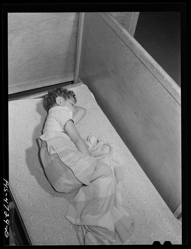 Queens, New York. Nursery school at the Queensbridge housing project. Child taking an afternoon nap