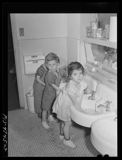Queens, New York. Nursery school at the Queensbridge housing project. Children washing before lunch