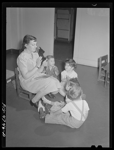 Queens, New York. Nursery school at the Queensbridge housing project. Nursery workers singing with the children