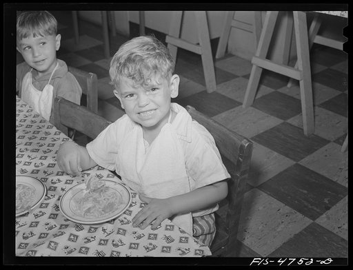 Untitled photo, possibly related to: Queens, New York. Nursery school at the Queensbridge housing project. Nursery worker helping children eat lunch