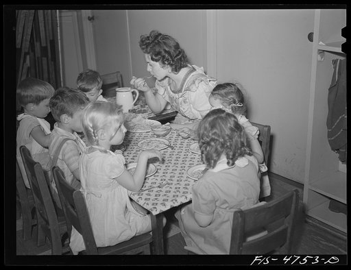 Untitled photo, possibly related to: Queens, New York. Nursery school at the Queensbridge housing project. Nursery worker helping children eat lunch