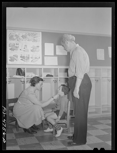Queens, New York. Nursery school at the Queensbridge housing project. Children are examined each morning when they are admitted to the nursery school