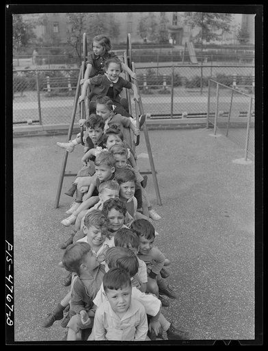 Queens, New York. Nursery school at the Queensbridge housing project. Children on a slide
