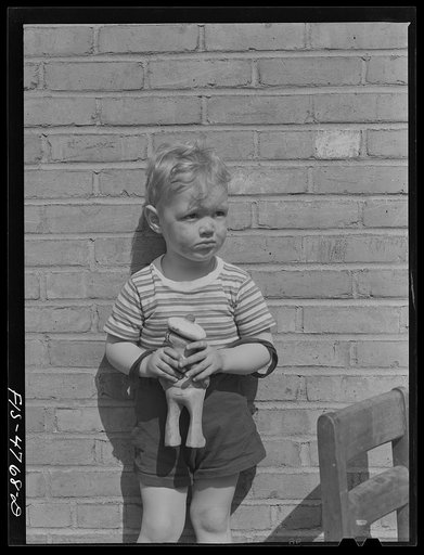 Queens, New York. Child with doll at the nursery school at Queensbridge housing project
