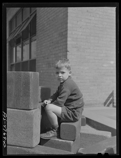 Queens, New York. Child with blocks at the nursery school at Queensbridge housing project