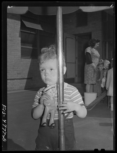 Queens, New York. Child with doll at the nursery school at Queensbridge housing project