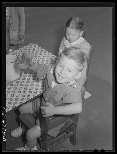 Queens, New York. Children get milk or tomato juice after their nap at the nursery school at Queensbridge housing project