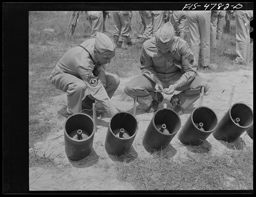 Edgewood Arsenal, Maryland. Gas demonstration. Attaching electrical detonating mechanism to Livens projectors