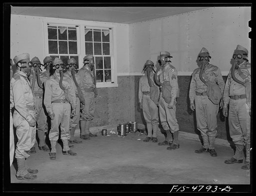 Edgewood Arsenal, Maryland. Gas demonstration. Soldiers in the gas chamber filled with tear gas which emanates from cans on the floor in the corner