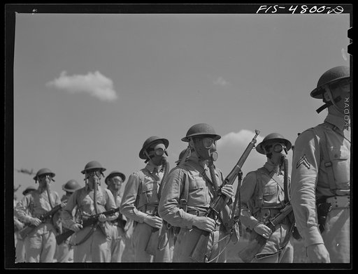 Edgewood Arsenal, Maryland. Gas demonstration. Soldiers wearing gas masks after having been sprayed with gas from a plane