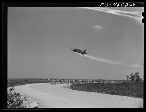 Edgewood Arsenal, Maryland. Gas demonstration. Plane spraying tear gas on a column of soldiers